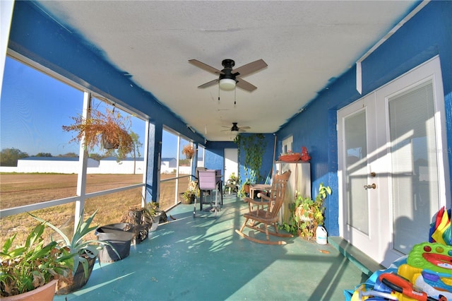 sunroom / solarium featuring ceiling fan