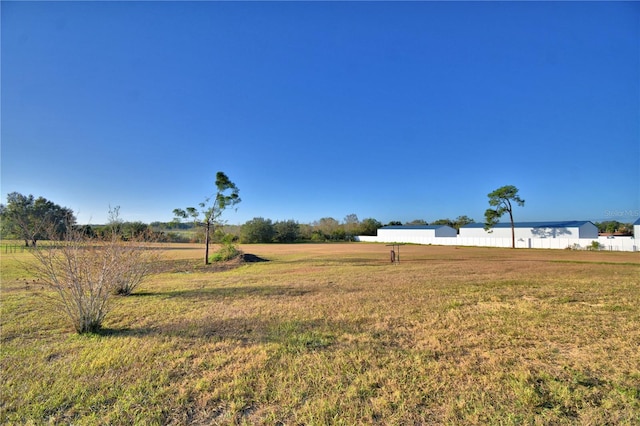 view of yard with a rural view