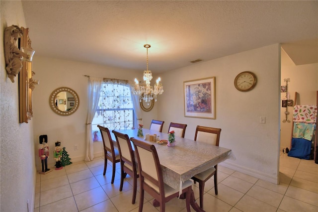 dining room with light tile patterned floors, a chandelier, and a textured ceiling