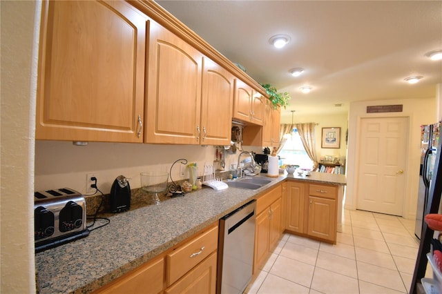 kitchen with sink, light tile patterned floors, decorative light fixtures, and appliances with stainless steel finishes