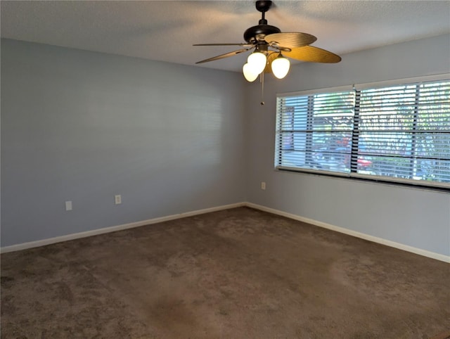 unfurnished room with dark colored carpet, a textured ceiling, and ceiling fan