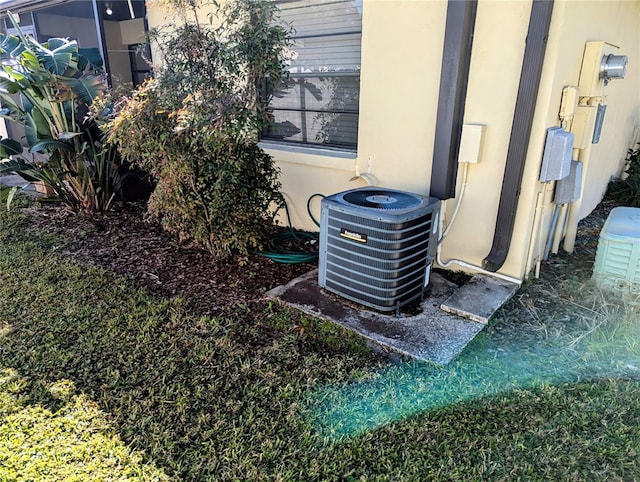 exterior details with cooling unit and stucco siding