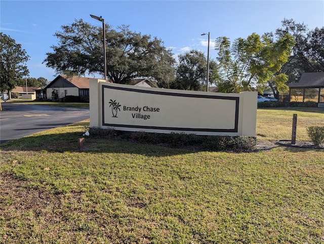 community sign featuring a yard