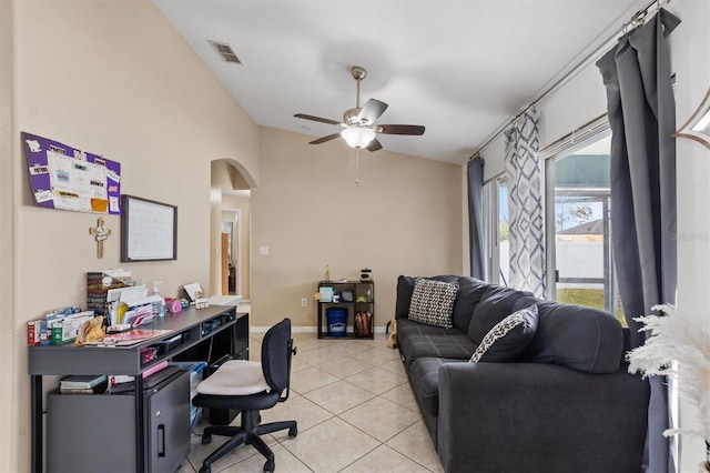 home office featuring ceiling fan, light tile patterned floors, and lofted ceiling