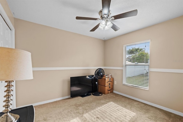 misc room with light carpet and ceiling fan