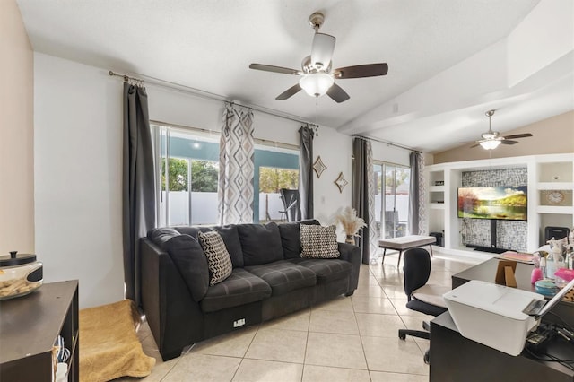 living room featuring light tile patterned floors, plenty of natural light, lofted ceiling, and ceiling fan