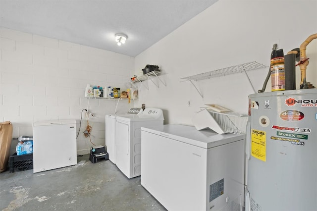 clothes washing area with washer and dryer, electric water heater, and a textured ceiling