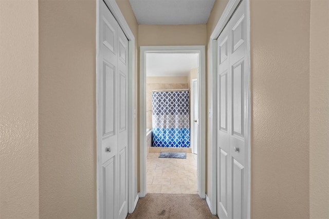 corridor featuring light tile patterned flooring