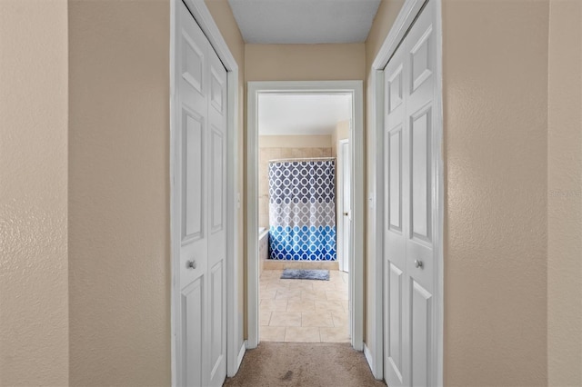 910 Nancy Ct, Kissimmee, FL 34759 - corridor with carpet floors and a textured wall