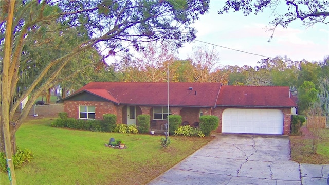 ranch-style home featuring a garage and a front yard