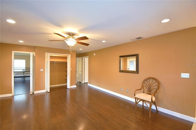 interior space with ceiling fan and dark wood-type flooring