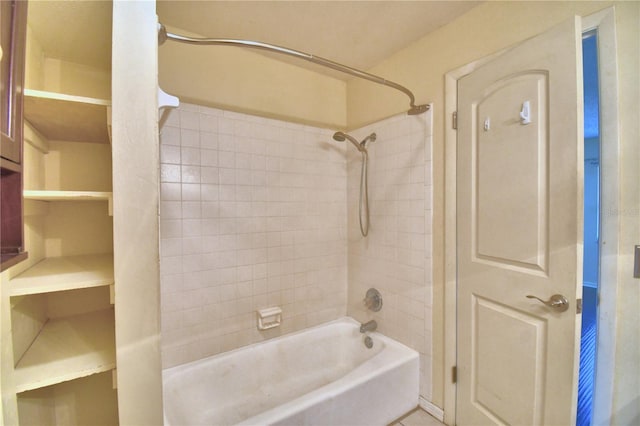 bathroom with tile patterned floors and tiled shower / bath