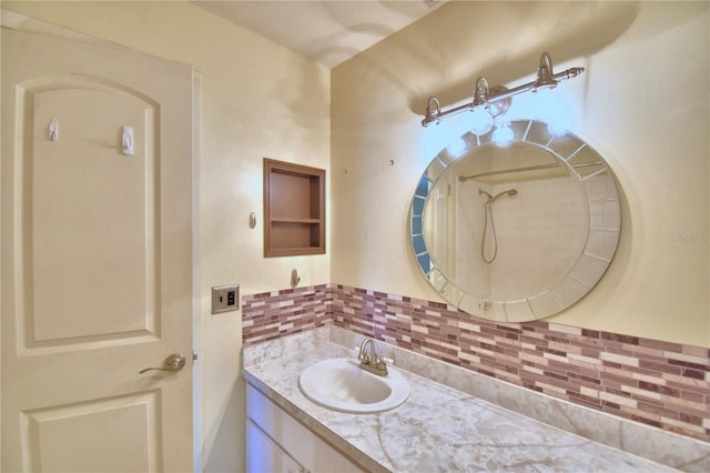 bathroom with vanity, backsplash, and walk in shower