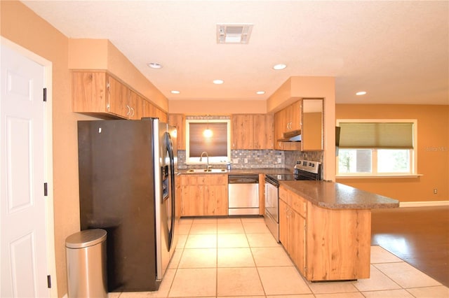 kitchen with decorative backsplash, sink, light tile patterned floors, and stainless steel appliances