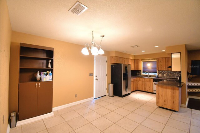 kitchen featuring decorative backsplash, light tile patterned floors, decorative light fixtures, stainless steel appliances, and a chandelier