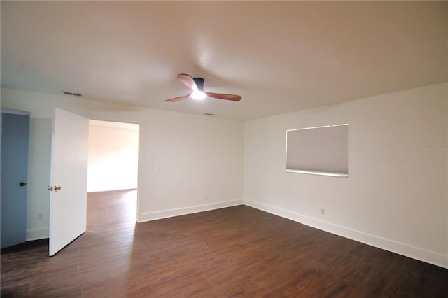 unfurnished room with ceiling fan and dark wood-type flooring