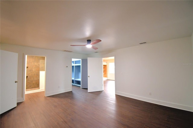 empty room with dark hardwood / wood-style floors and ceiling fan