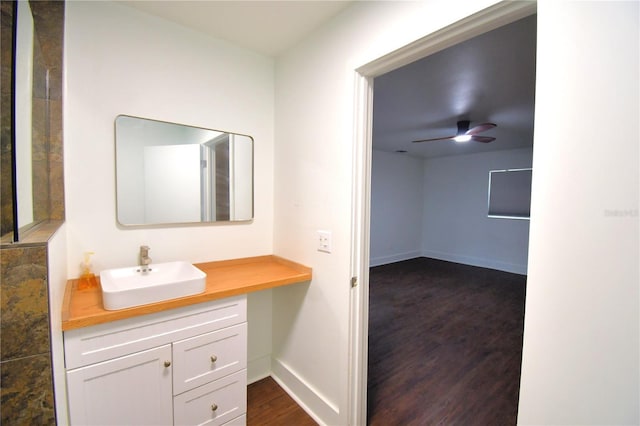 bathroom with ceiling fan, hardwood / wood-style floors, and vanity