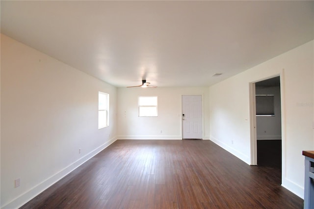 empty room featuring ceiling fan and dark wood-type flooring