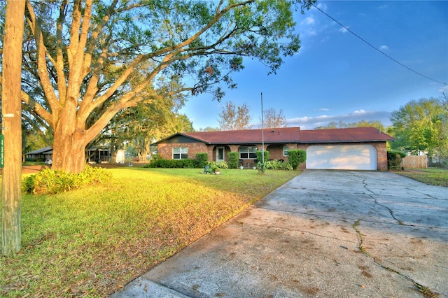 ranch-style home with a front yard and a garage