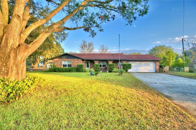 ranch-style home featuring a garage and a front lawn