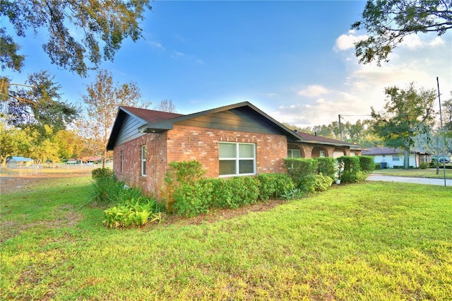 view of property exterior with a lawn