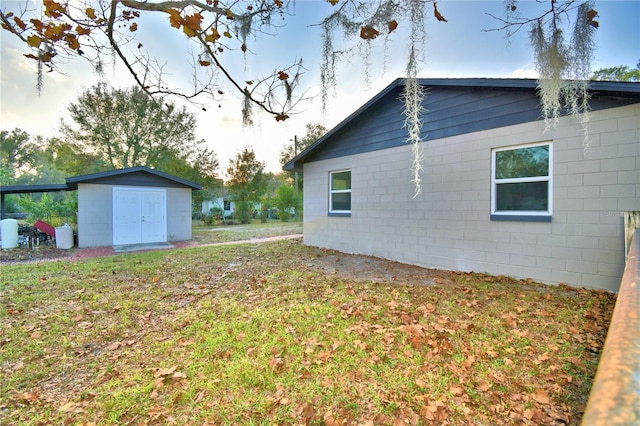 exterior space with a storage shed and a lawn