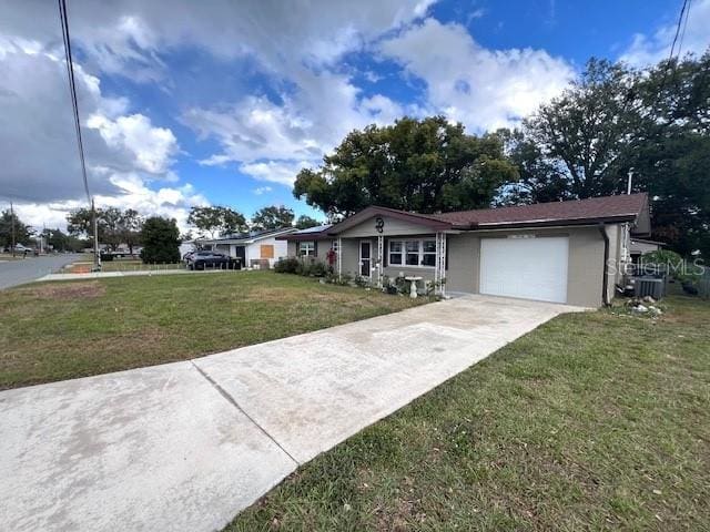 ranch-style home with cooling unit, a garage, and a front yard