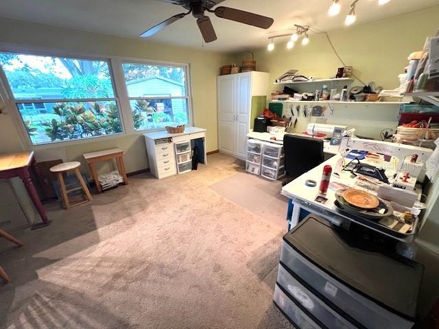 office featuring ceiling fan and light carpet