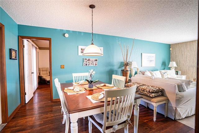 dining space featuring dark hardwood / wood-style floors and a textured ceiling