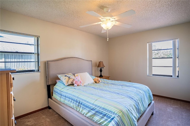 carpeted bedroom with a textured ceiling and ceiling fan