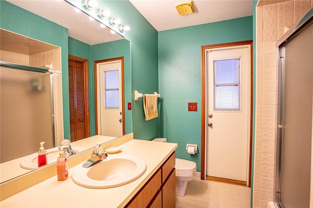 bathroom featuring tile patterned floors, toilet, and an enclosed shower