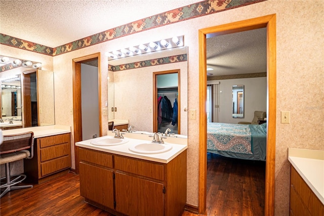 bathroom featuring vanity, a textured ceiling, and hardwood / wood-style flooring