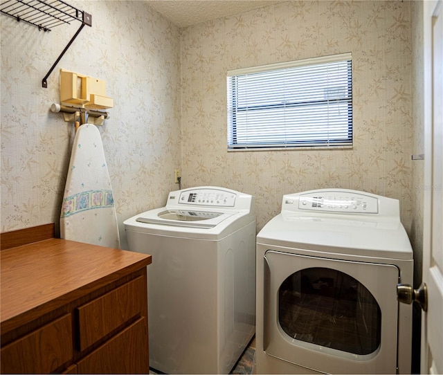 laundry room with washer and clothes dryer and a textured ceiling