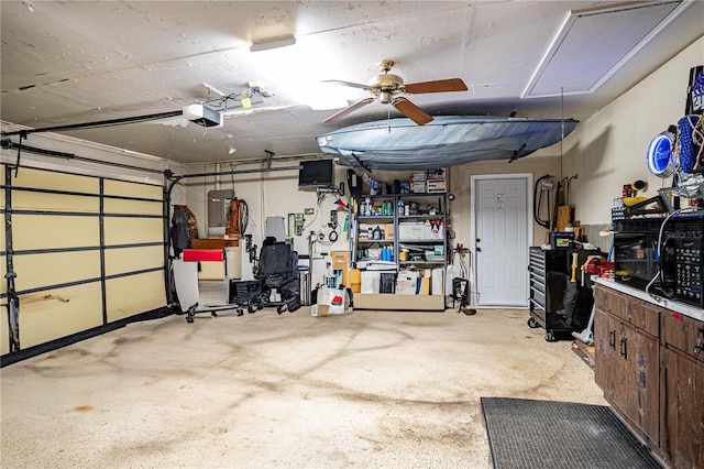 garage with a garage door opener and ceiling fan