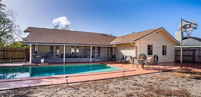 back of property featuring a sunroom and a patio area