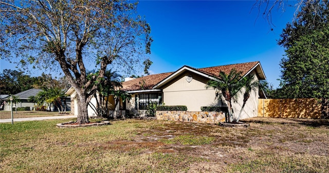 ranch-style home with a front lawn