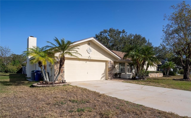 single story home featuring a garage and a front lawn