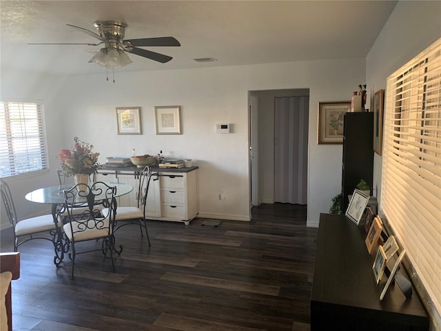 dining room featuring dark hardwood / wood-style floors and ceiling fan