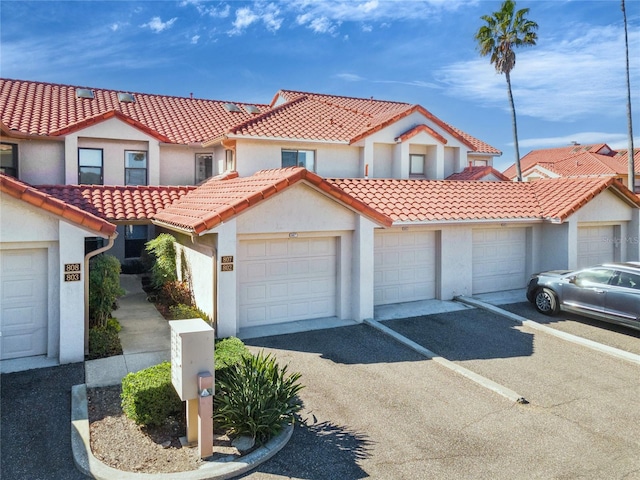 mediterranean / spanish home with a garage