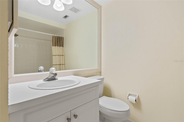 bathroom with vanity, toilet, and curtained shower