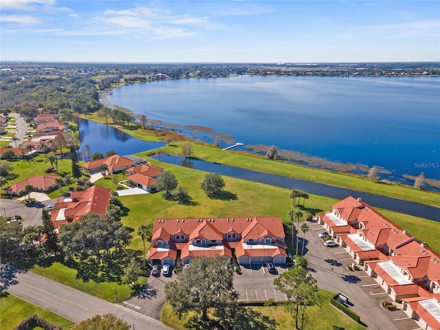 drone / aerial view featuring a residential view and a water view