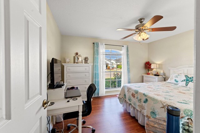 bedroom with ceiling fan and dark hardwood / wood-style flooring