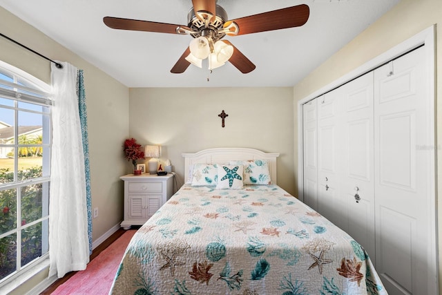 bedroom with ceiling fan and a closet