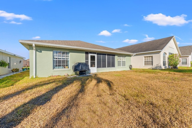 rear view of property with a lawn