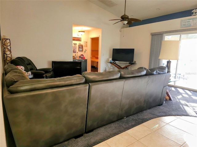 tiled living room with ceiling fan and lofted ceiling