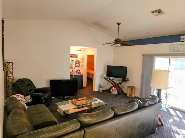 carpeted living room with ceiling fan and vaulted ceiling