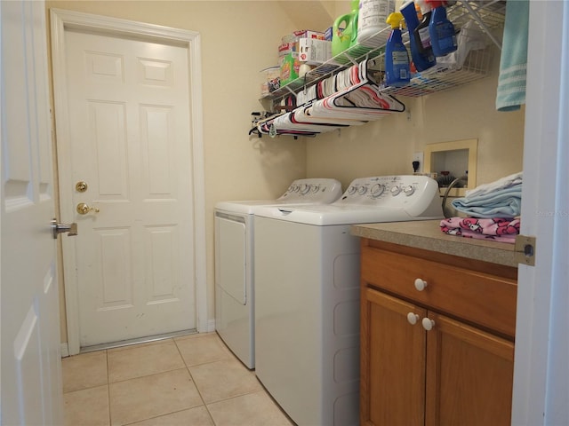 washroom with independent washer and dryer and light tile patterned floors