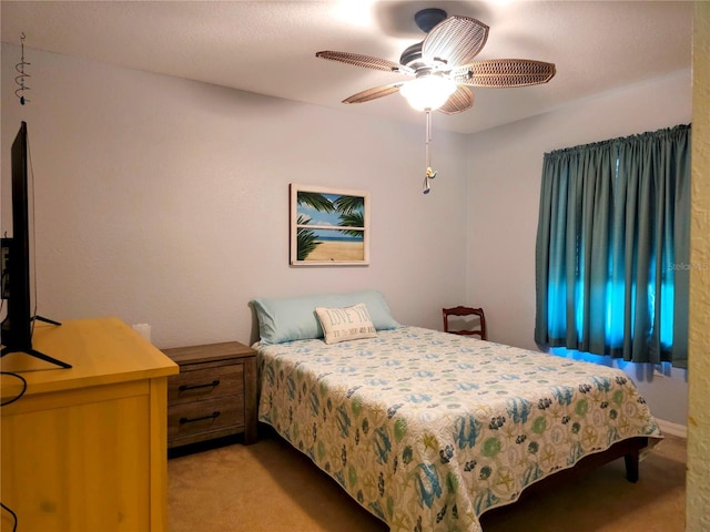 bedroom featuring light carpet and ceiling fan