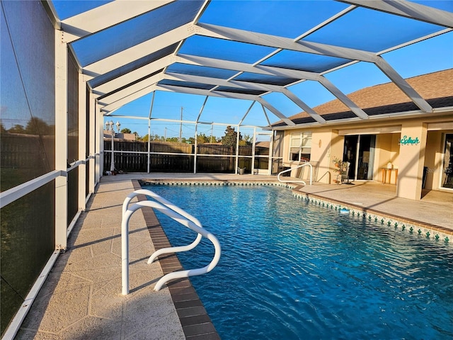 view of swimming pool featuring a patio and a lanai